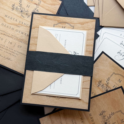 Wedding invitation with printed Wood Veneer flat cards, Madero Beach RSVP card, Black Thai Mulberry belly band, and Stone and Sirio Ultra Black envelopes